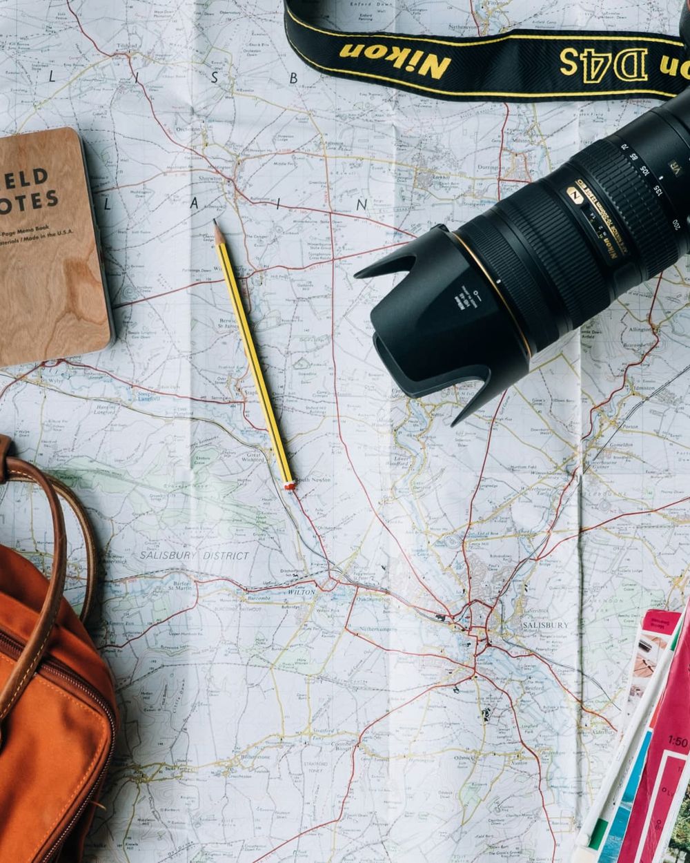 Travel planning desk with map, notebook and camera